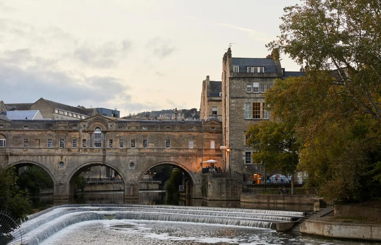 an old building with a water fountain in front of it at Hotel Indigo - Bath by IHG in Bath