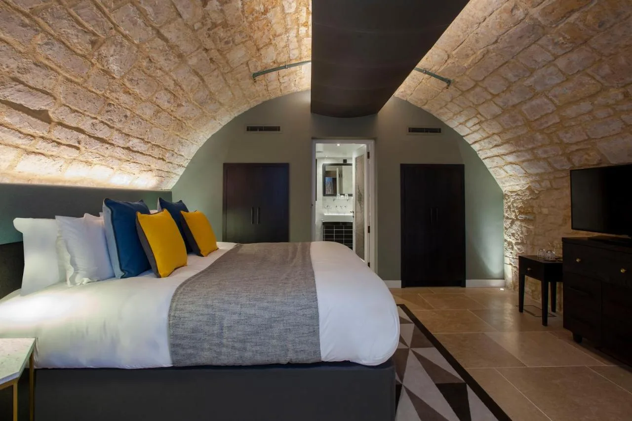 a bedroom with a large bed and a tv at Hotel Indigo - Bath by IHG in Bath